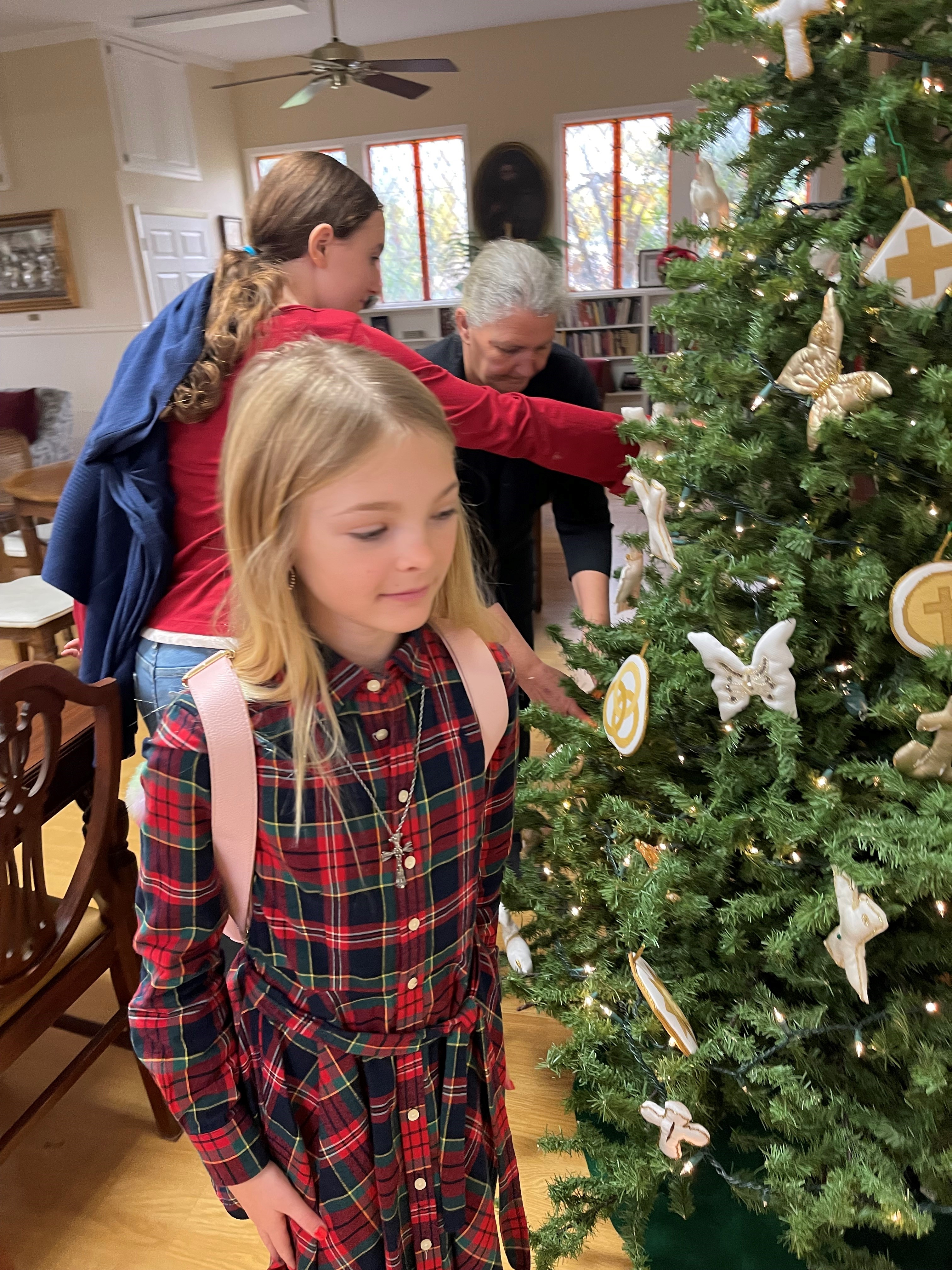 Image of Reese looking at the Chrismon Tree after the decorating